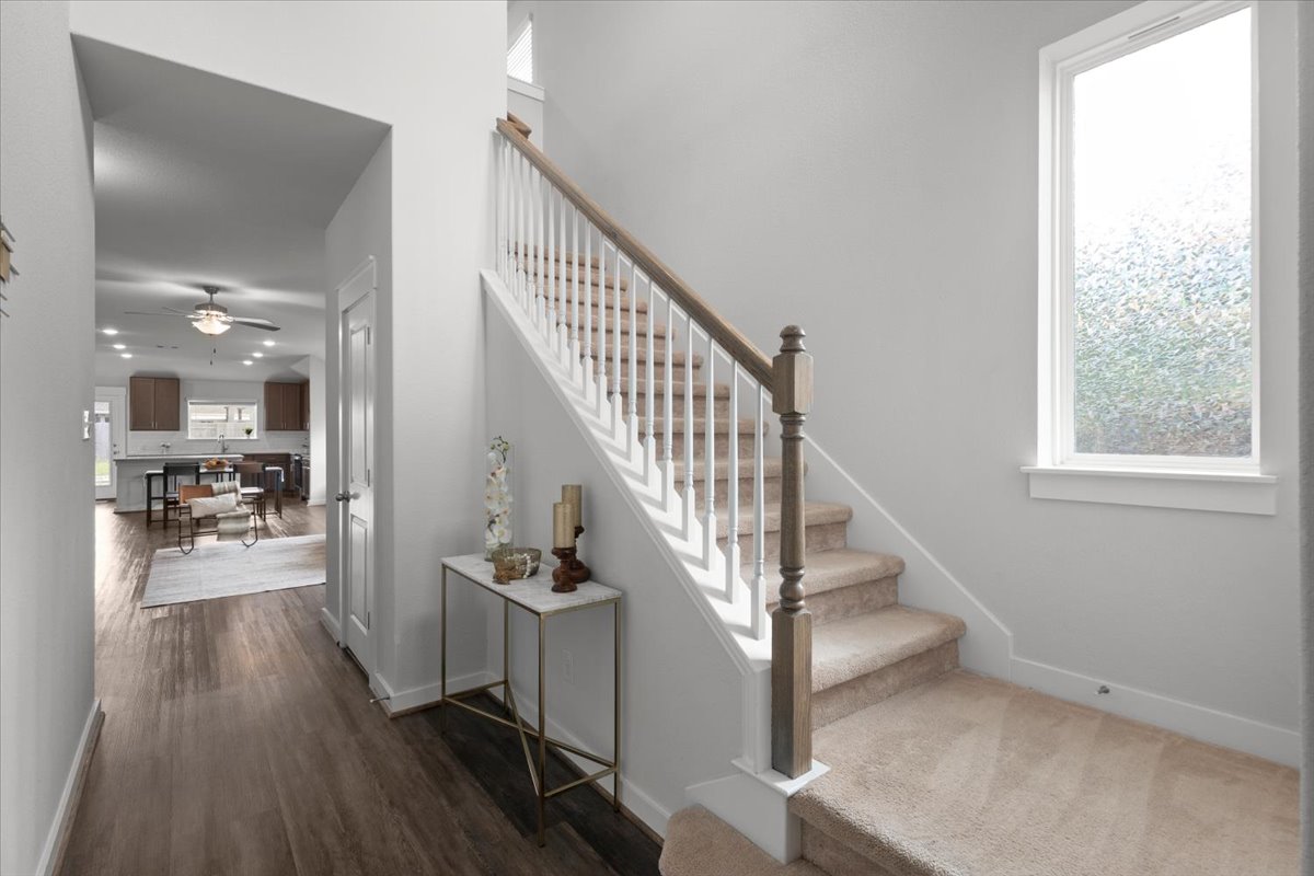 321 Buffalo View Lane Georgetown, TX 78628 - Photo 14 of 29 At the foyer, high ceilings welcome you home. The staircase with a wood handrail, white balusters and a prominent window flood in natural light