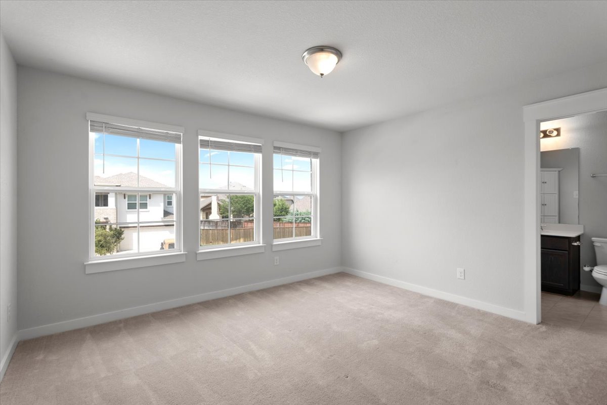 321 Buffalo View Lane Georgetown, TX 78628 - Photo 17 of 29 Bedroom #2 with large windows and en-suite bathroom