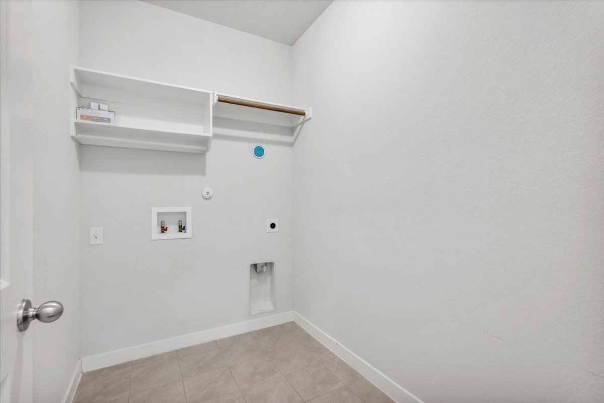 321 Buffalo View Lane Georgetown, TX 78628 - Photo 23 of 29 Dedicated utility area on main level with built-in shelving unit with a hanging rod