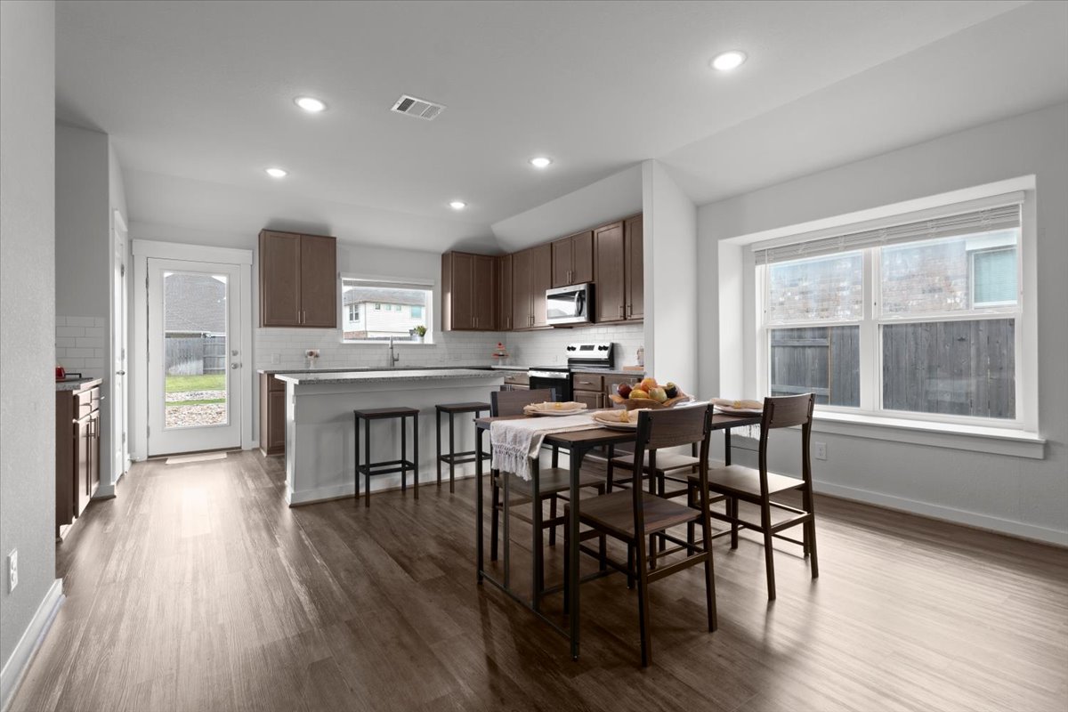 321 Buffalo View Lane Georgetown, TX 78628 - Photo 5 of 29 Open-concept kitchen and dining area featuring recessed lighting, wood-look flooring