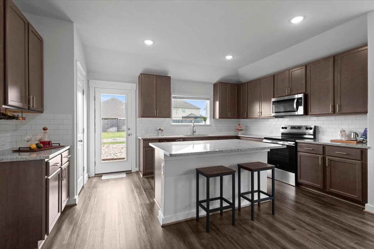 321 Buffalo View Lane Georgetown, TX 78628 - Photo 7 of 29 Tons of cabinets and island seating