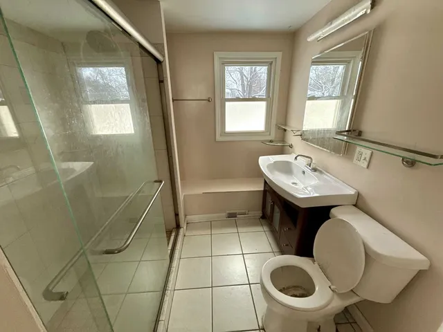 a bathroom with a sink toilet and shower