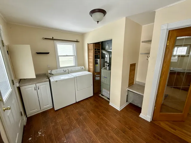 a view of a kitchen with cabinets and wooden floor