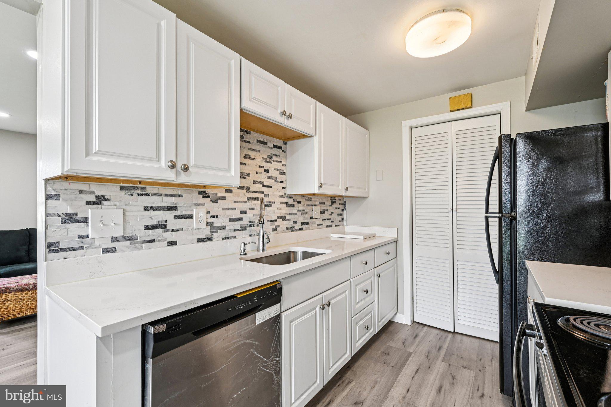 32 Coliston Road, Unit B Reisterstown, MD 21136 - Photo 11 of 24 a kitchen with a sink a refrigerator and cabinets