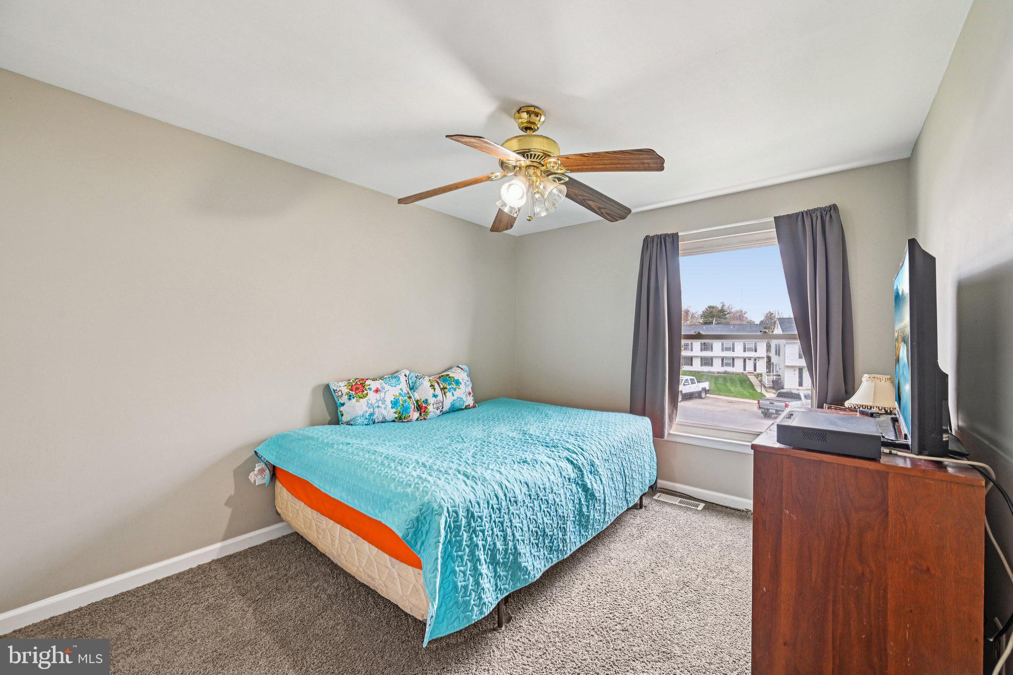 32 Coliston Road, Unit B Reisterstown, MD 21136 - Photo 12 of 24 a bedroom with a bed and a chandelier