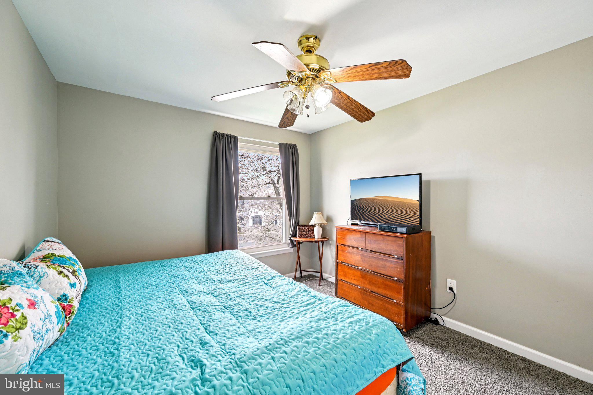 32 Coliston Road, Unit B Reisterstown, MD 21136 - Photo 13 of 24 a bedroom with a bed and a chandelier