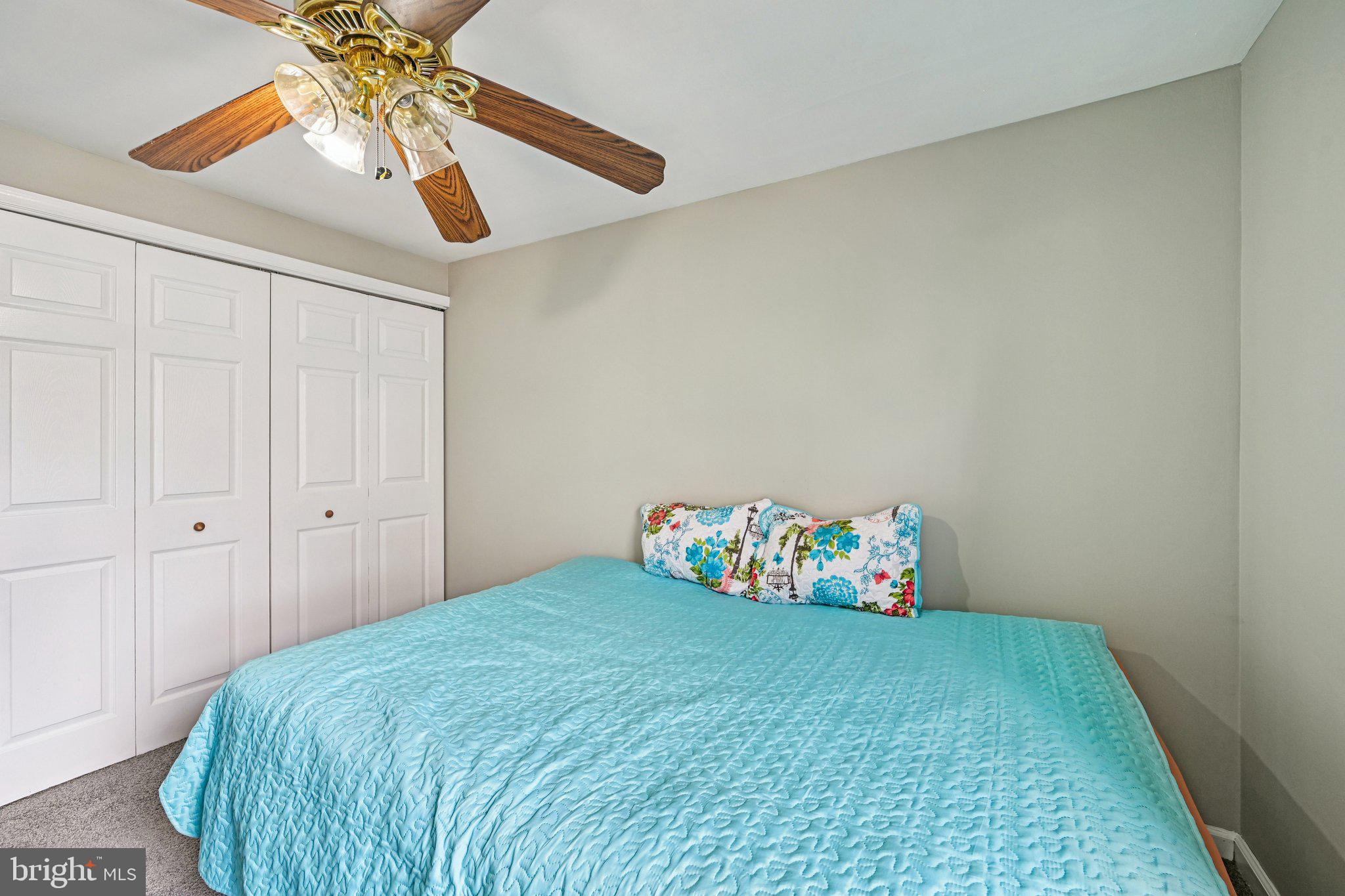 32 Coliston Road, Unit B Reisterstown, MD 21136 - Photo 14 of 24 a bedroom with a bed and a chandelier