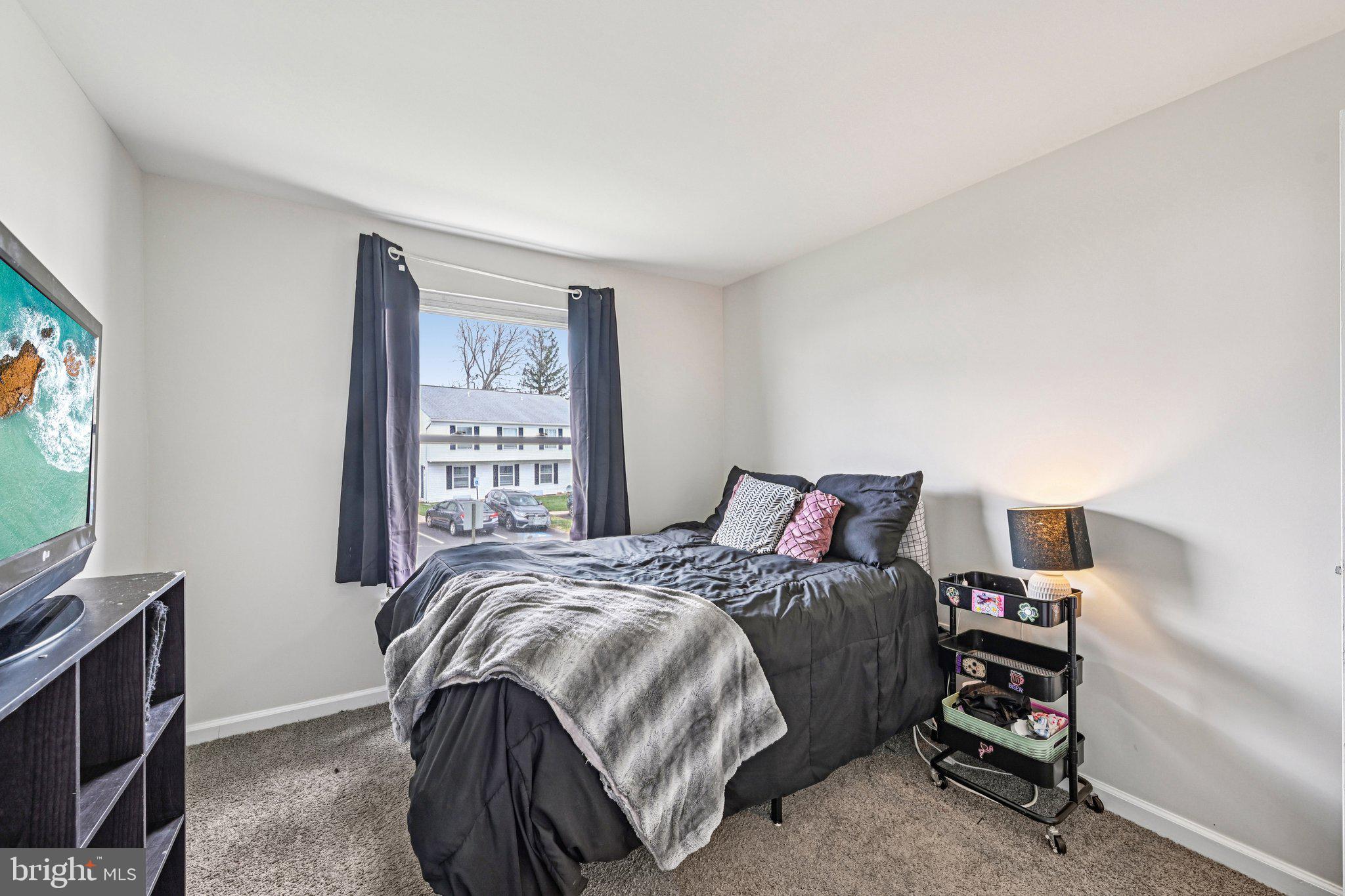 32 Coliston Road, Unit B Reisterstown, MD 21136 - Photo 17 of 24 a bedroom with a bed and a flat screen tv