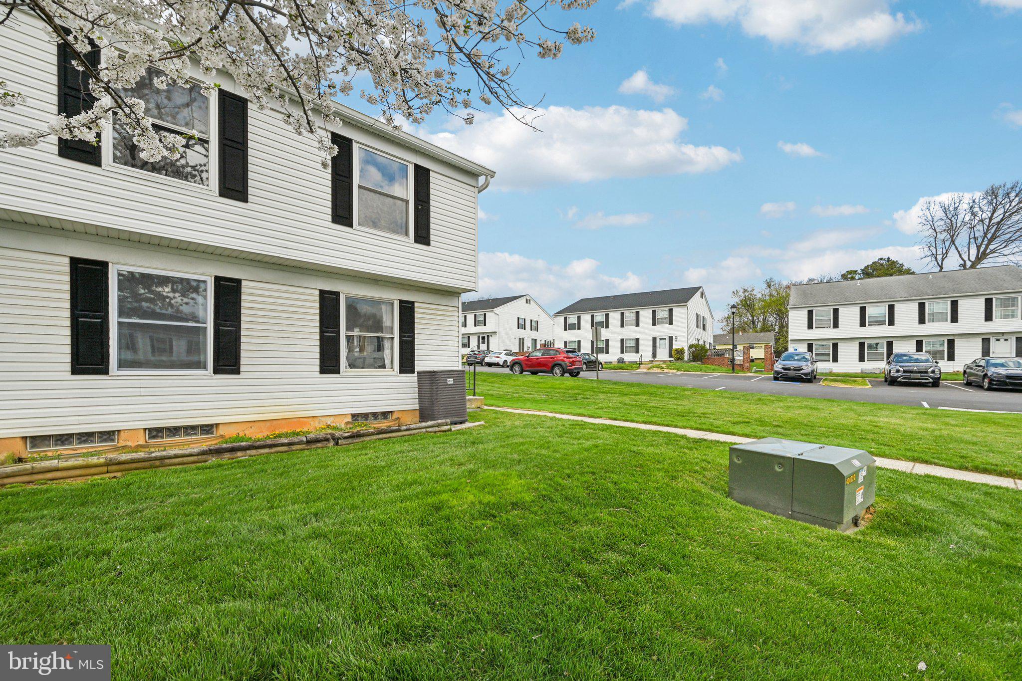 32 Coliston Road, Unit B Reisterstown, MD 21136 - Photo 24 of 24 a front view of a house with a yard table and chairs