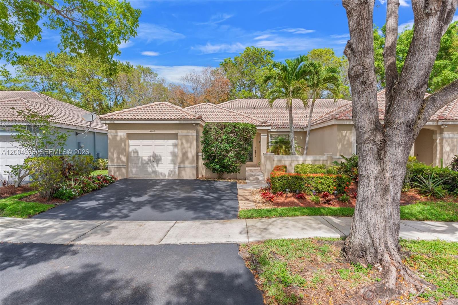 4108 Pine Ridge Lane Weston, FL 33331 - Photo 1 of 37 a front view of a house with a yard