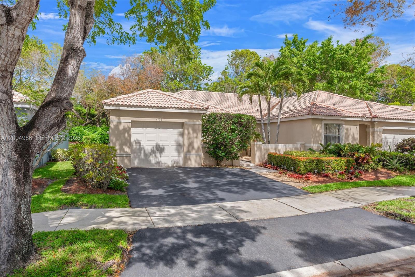 4108 Pine Ridge Lane Weston, FL 33331 - Photo 3 of 37 a front view of a house with a yard and outdoor seating