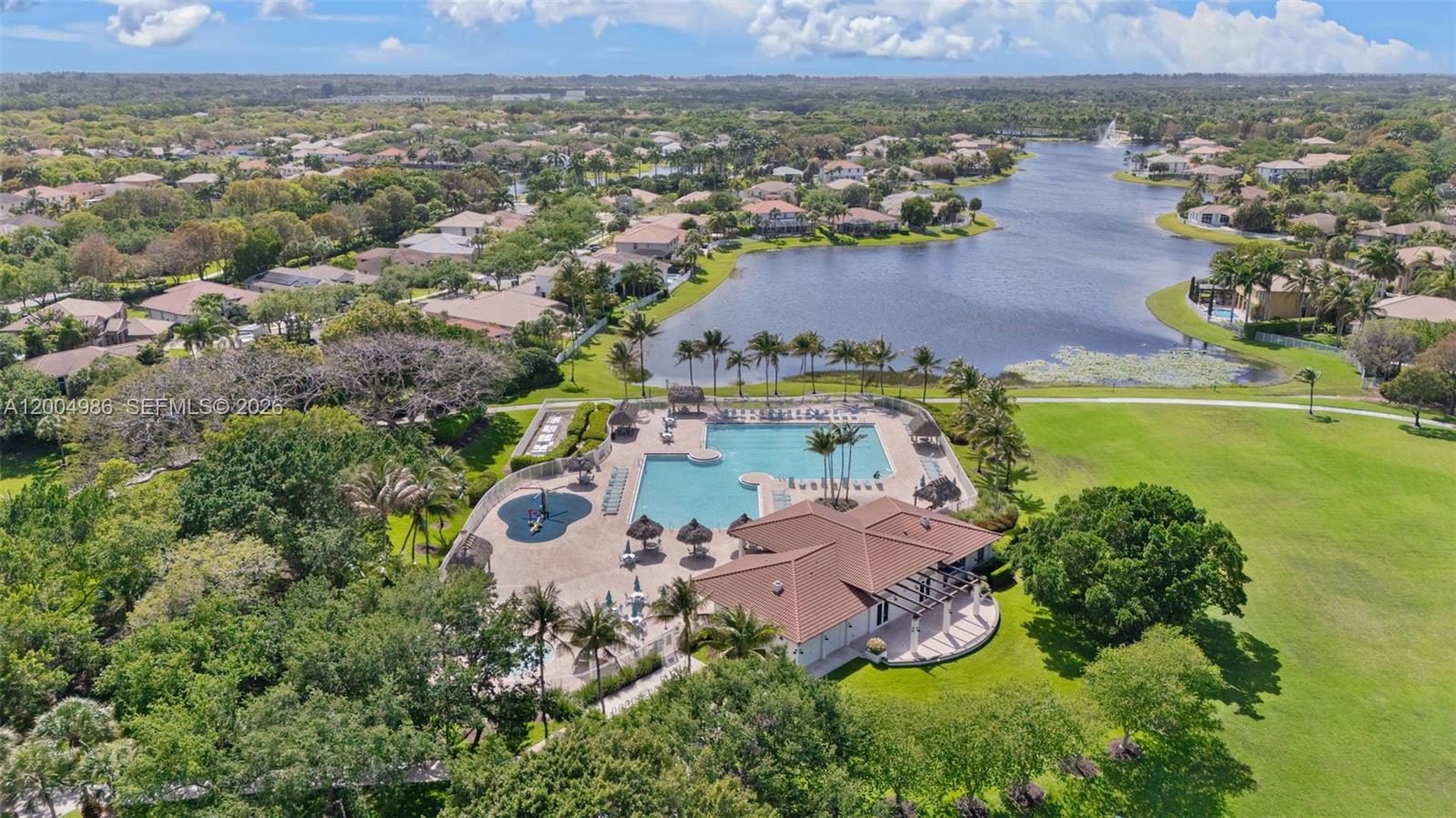 4108 Pine Ridge Lane Weston, FL 33331 - Photo 31 of 37 an aerial view of a house with a garden and lake view