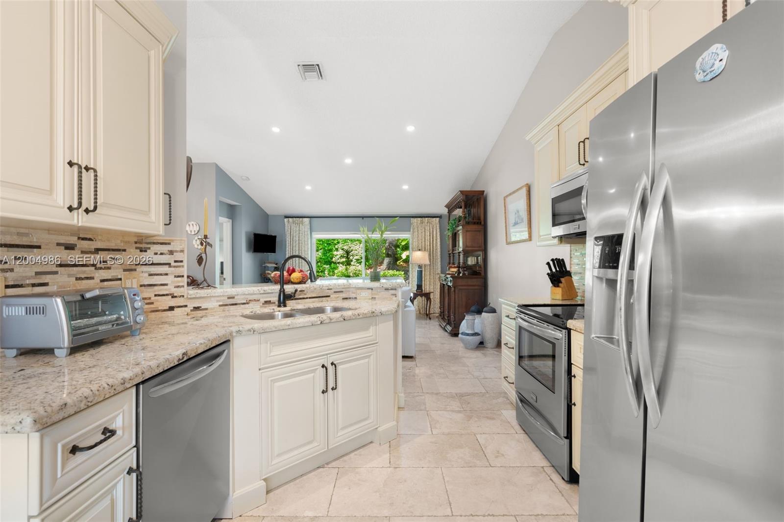 4108 Pine Ridge Lane Weston, FL 33331 - Photo 6 of 37 a kitchen with stainless steel appliances granite countertop a sink stove and refrigerator