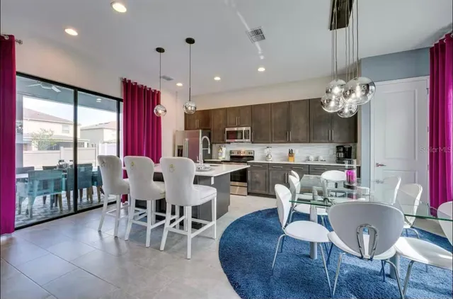 a view of a dining room with furniture a chandelier and wooden floor