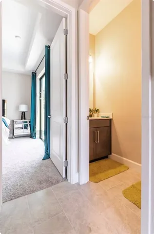 a view of a room that has a dresser and mirror in it