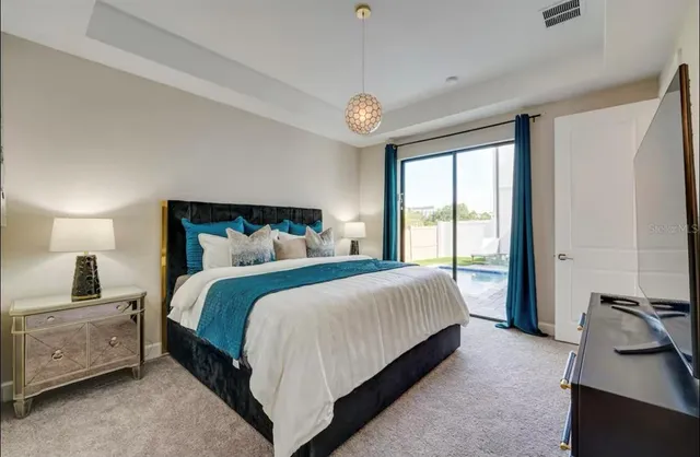 a bedroom with a large bed and a window