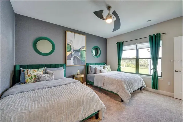 a bedroom with two beds and a chandelier