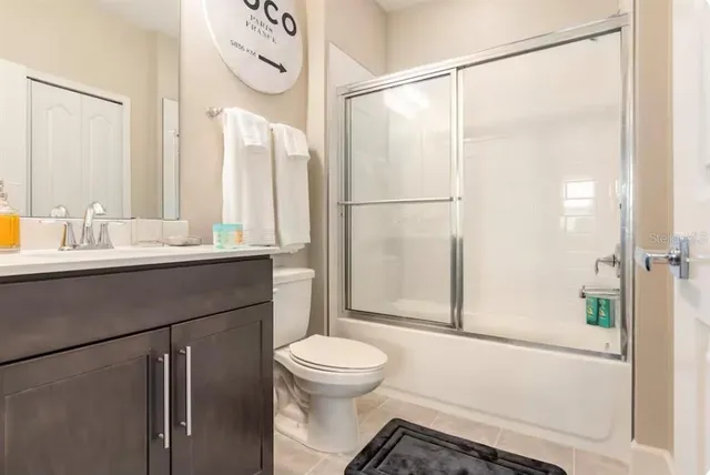 a bathroom with a sink a toilet and a shower