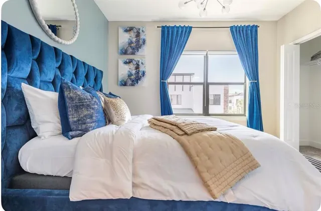 a bedroom with a large bed and a window