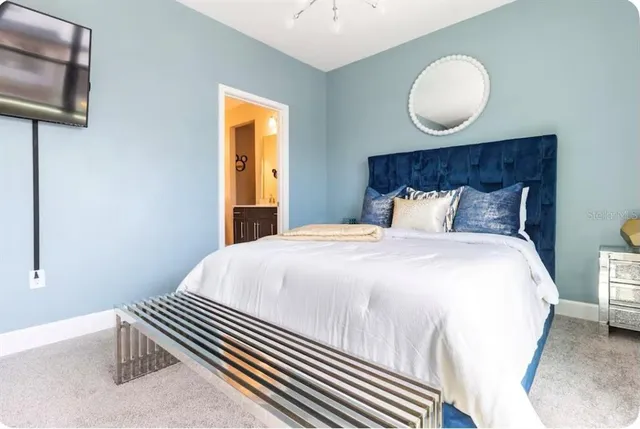 a bedroom with bed and wooden floor