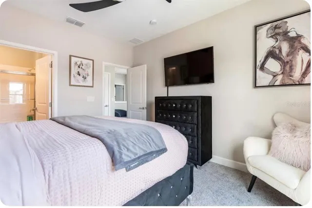 a bedroom with a bed and a television