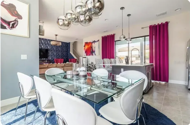 a dining room with furniture a chandelier and wooden floor