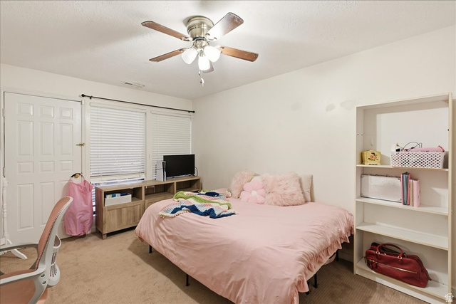 1334 Ridgewood Lane Bountiful, UT 84010 - Photo 32 of 38 Ceiling fan with light fixture, window with blinds, wood-finish media console, built-in shelving, panel door