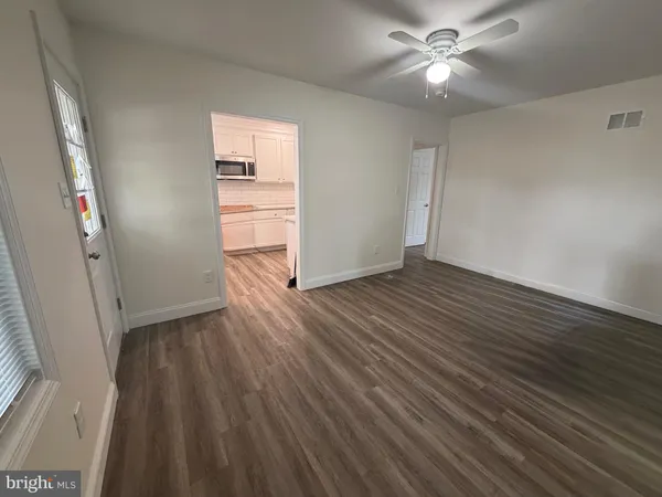 wooden floor in an empty room with a window