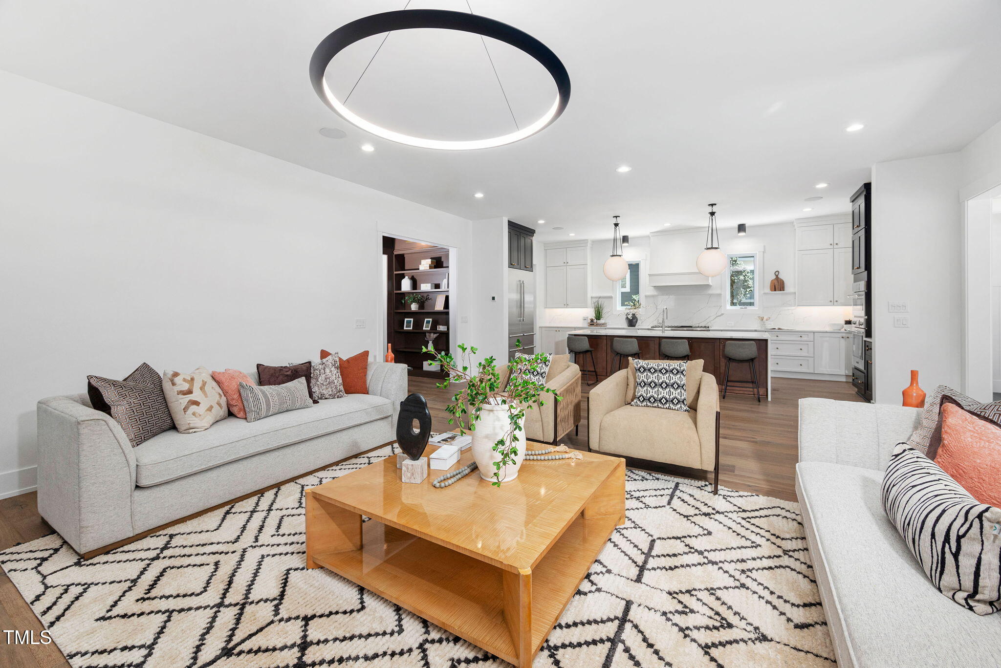 604 Edmund Street Raleigh, NC 27604 - Photo 10 of 70 a living room with furniture a rug and a chandelier