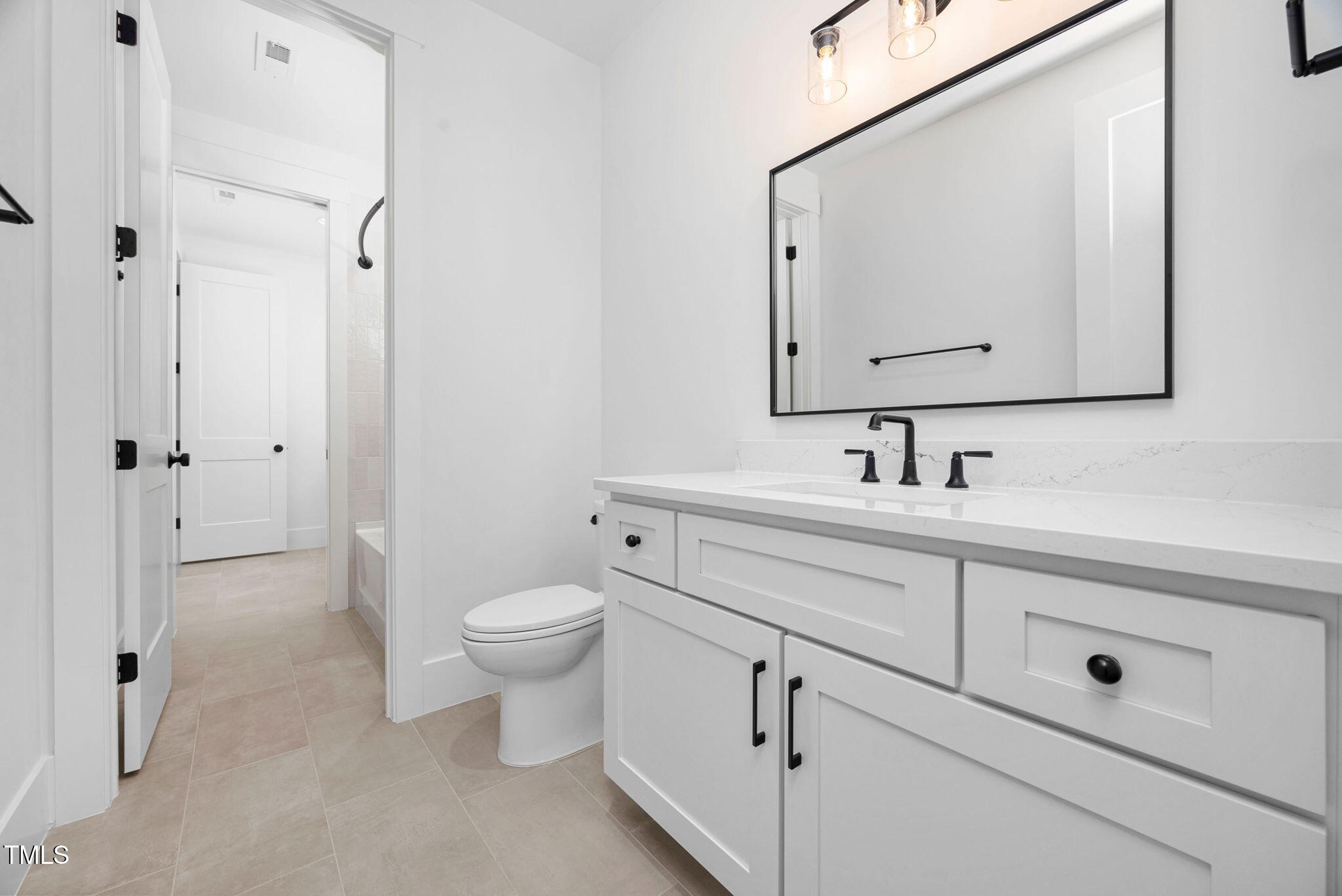 604 Edmund Street Raleigh, NC 27604 - Photo 38 of 70 a bathroom with a toilet sink and mirror