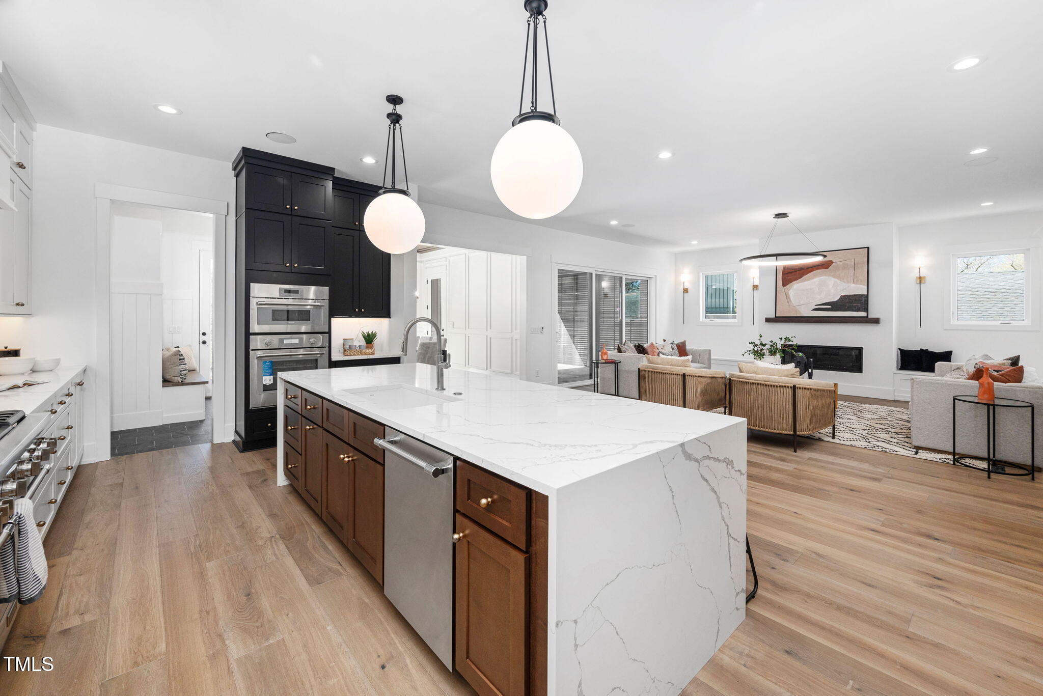 604 Edmund Street Raleigh, NC 27604 - Photo 5 of 70 a large kitchen with stainless steel appliances kitchen island granite countertop a stove a sink a dining table and chairs with wooden floor