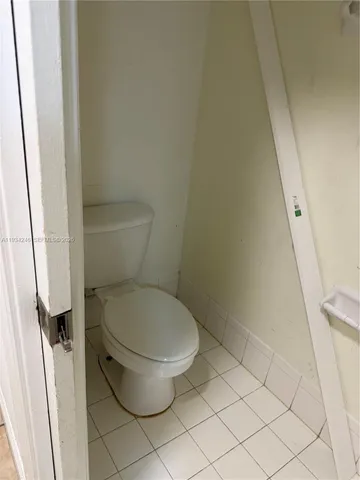 a white toilet sitting next to a sink and vanity