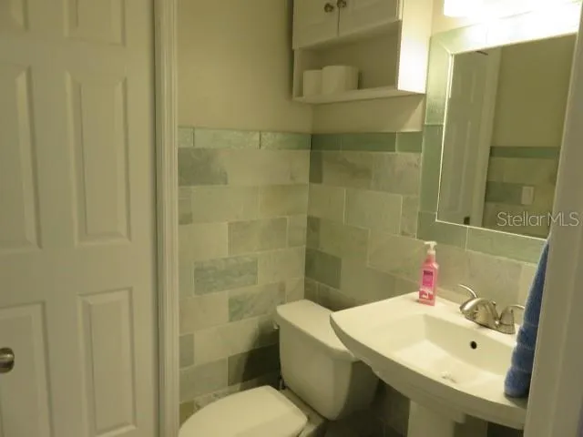 a bedroom with a bed and painting on the wall