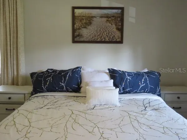a living room with wooden floor and flat screen tv