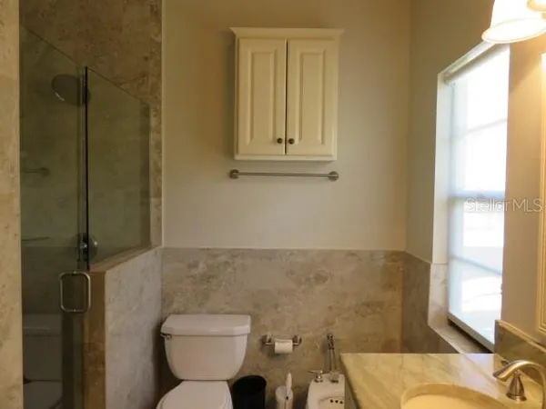 a bathroom with a granite countertop sink a mirror and a bathtub