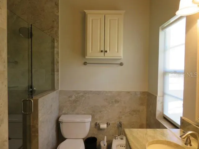 a bathroom with a granite countertop sink a mirror and a bathtub