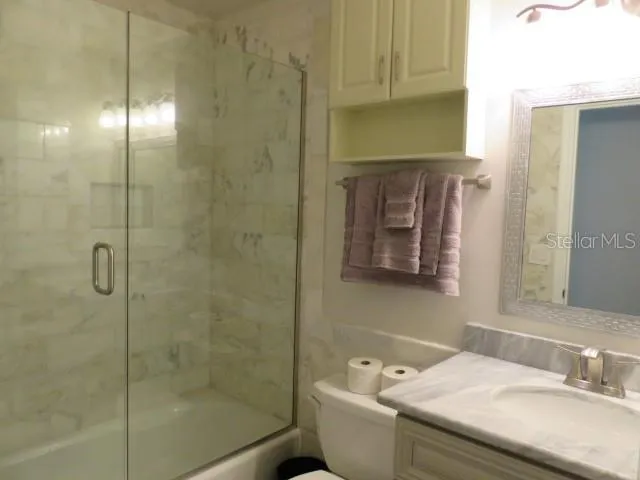 a large bed sitting in a bedroom next to a window