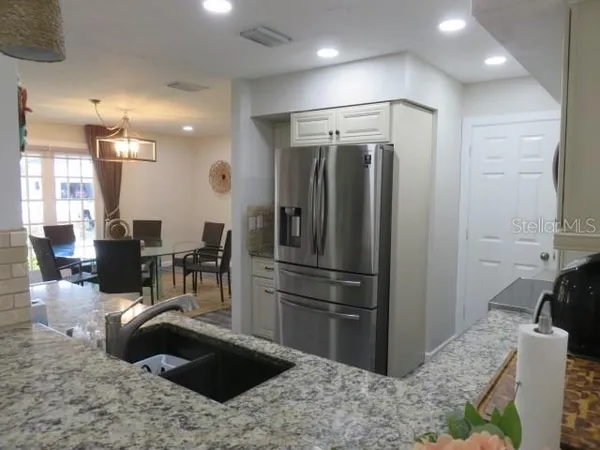 a kitchen with a refrigerator and a sink