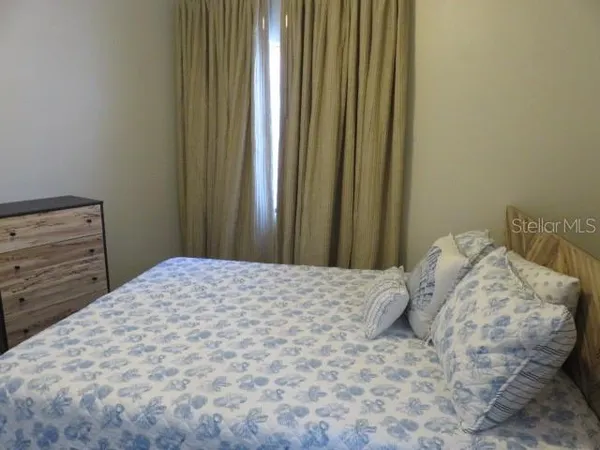 a bedroom with a bed and a wall painting