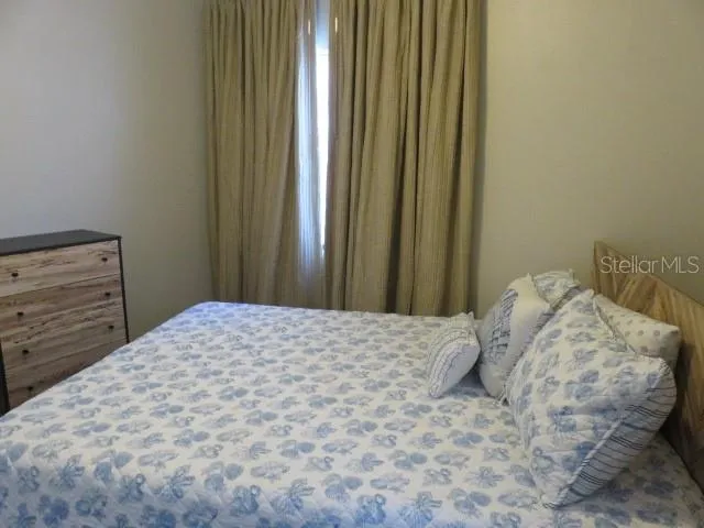 a bedroom with a bed and a wall painting