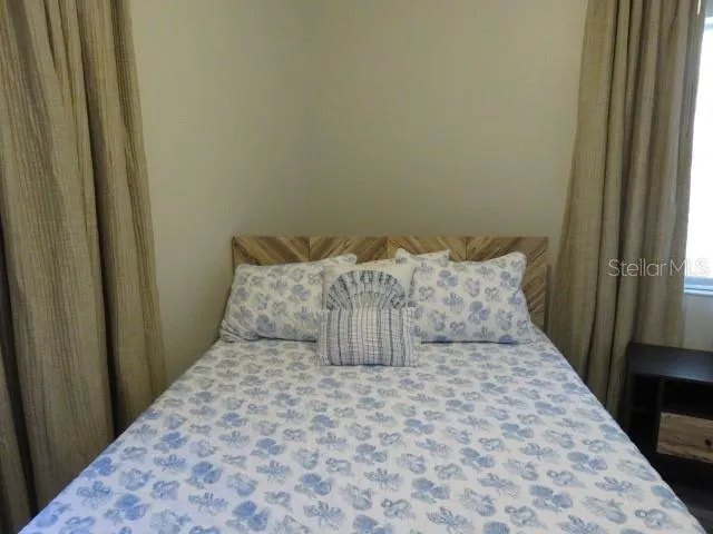 a bedroom with a bed and a ceiling fan