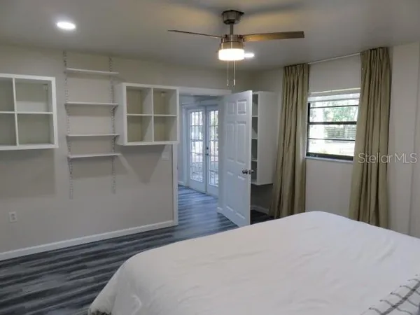 a bedroom with furniture and a window