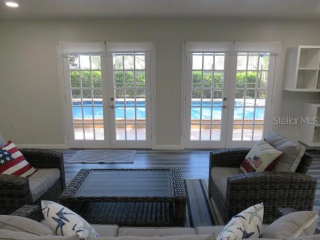 a bed sitting in a balcony next to a yard