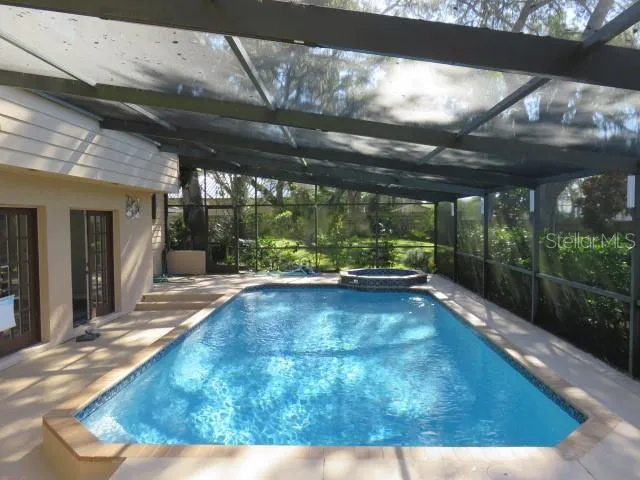 a view of a backyard with swimming pool