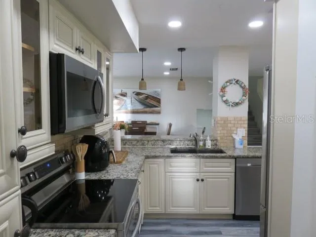 a kitchen with a sink stove and cabinets