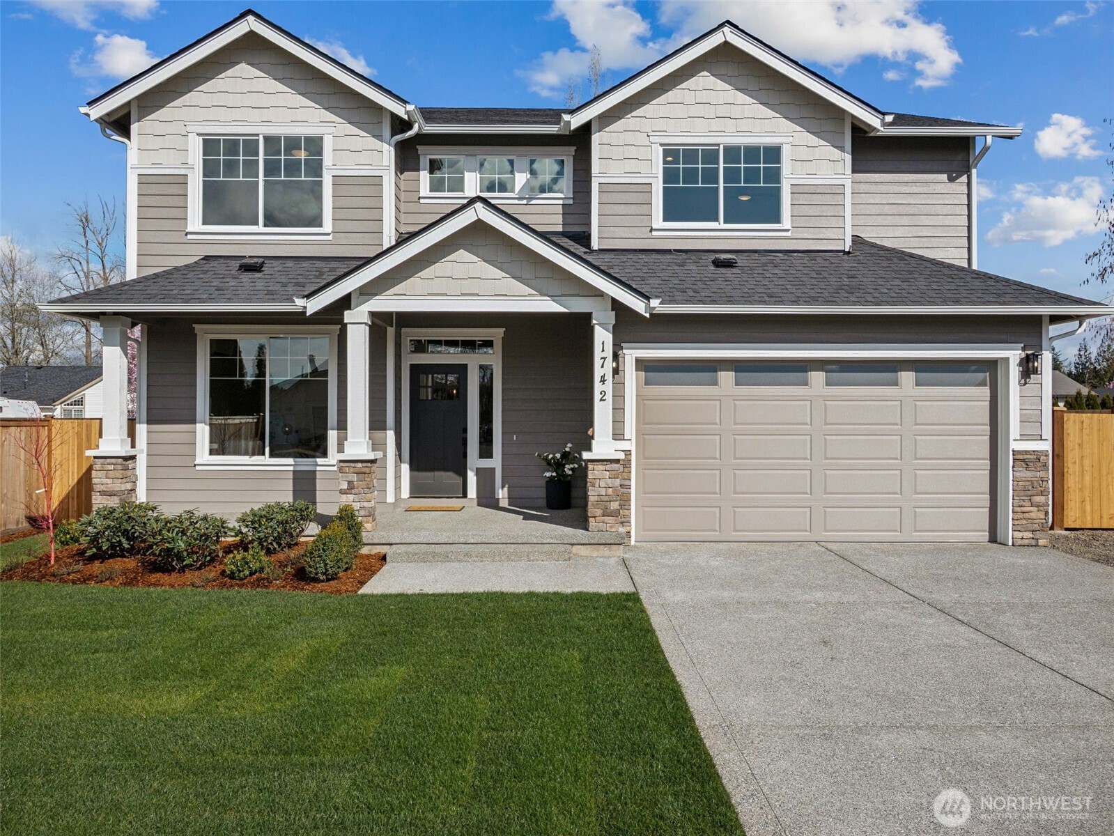 1742 Fieldcrest Place Buckley, WA 98321 - Photo 2 of 27 a front view of a house with a garden and plants