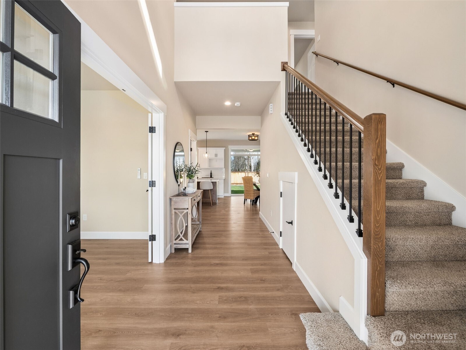 1742 Fieldcrest Place Buckley, WA 98321 - Photo 3 of 27 a view of staircase with lots of frames on wall and wooden floor