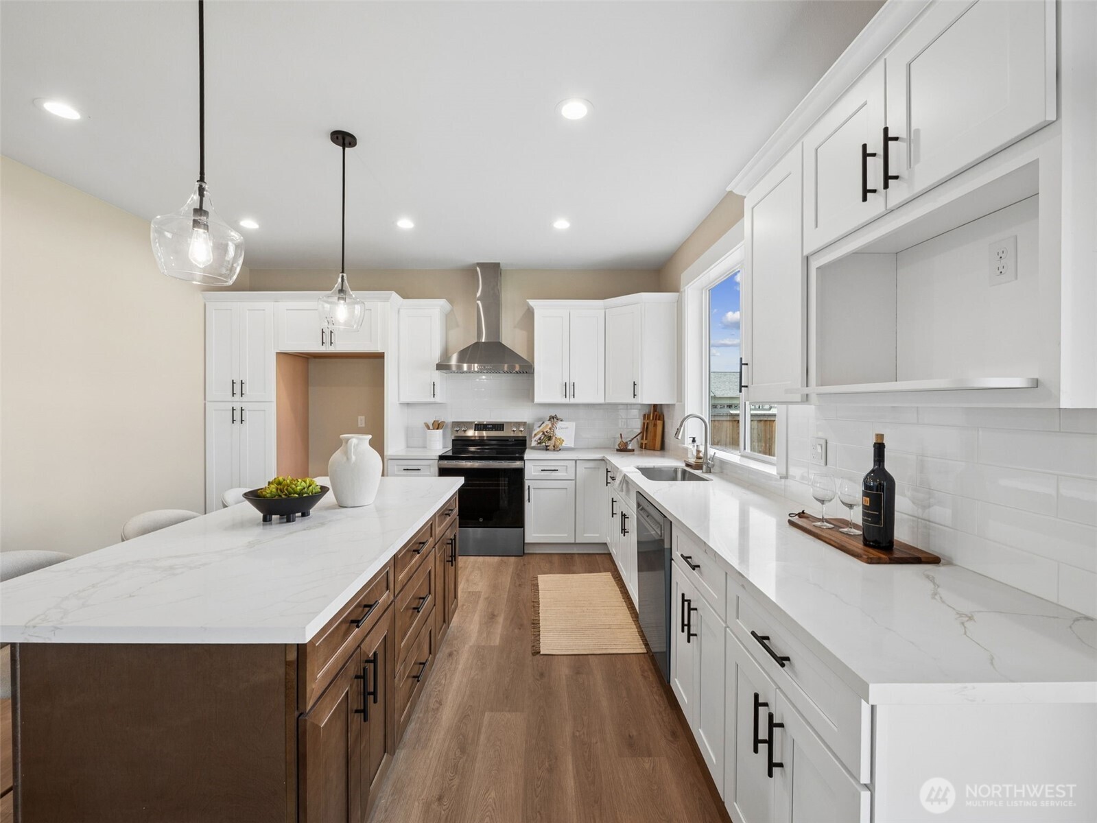 1742 Fieldcrest Place Buckley, WA 98321 - Photo 7 of 27 a kitchen with stainless steel appliances kitchen island granite countertop a sink a stove and a wooden floors