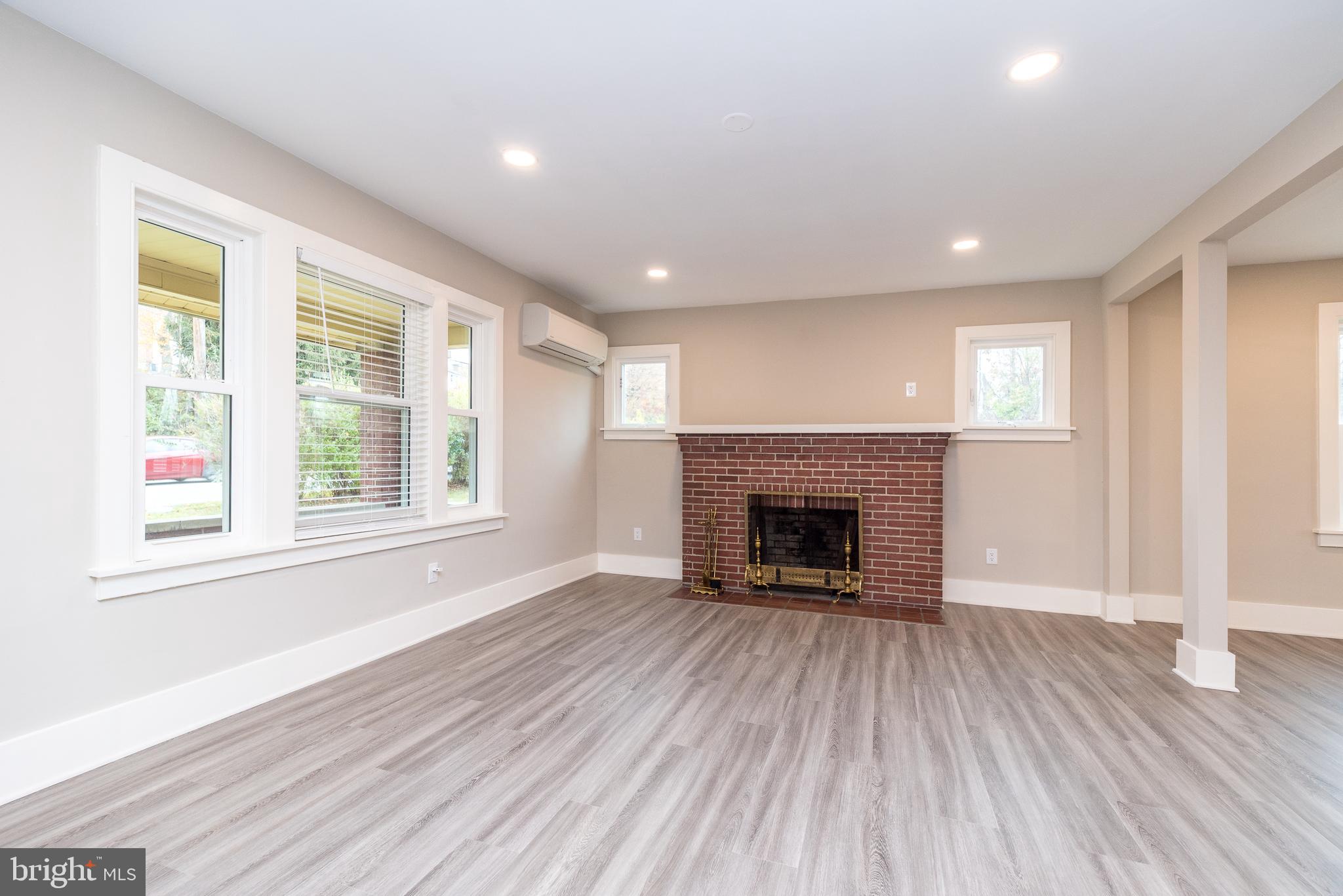 343 Pawlings Road Phoenixville, PA 19460 - Photo 3 of 50 a view of an empty room with wooden floor fireplace and a window