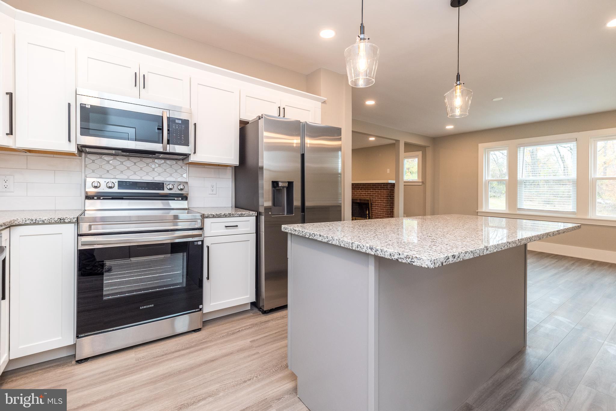 343 Pawlings Road Phoenixville, PA 19460 - Photo 8 of 50 a kitchen with stainless steel appliances granite countertop a stove a sink and a refrigerator